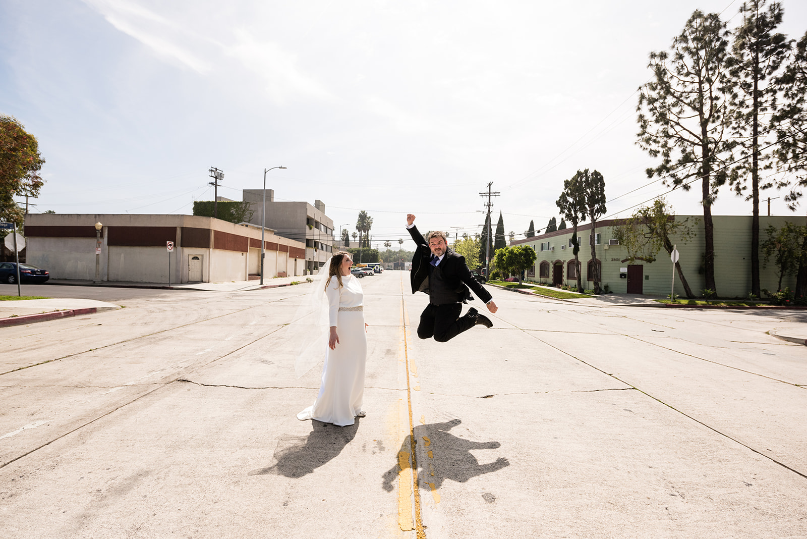 Couple jumping for joy on their wedding day